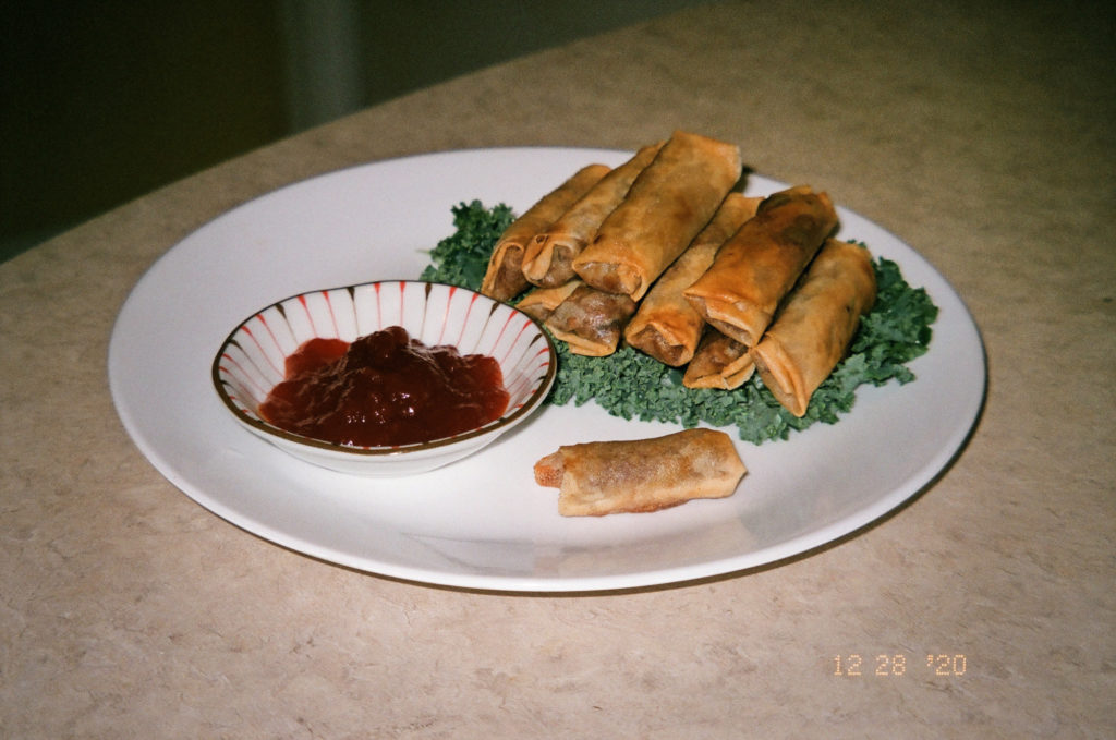 A stack of fried lumpia served with banana ketchup