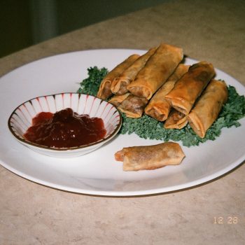 A stack of fried lumpia served with banana ketchup